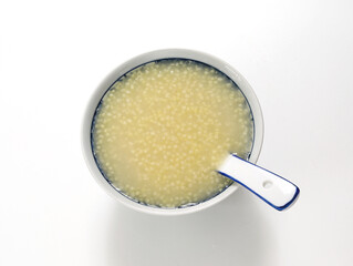 A bowl of nutritious breakfast millet porridge on the white table