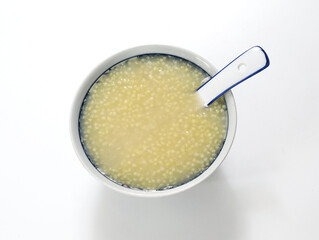 A bowl of nutritious breakfast millet porridge on the white table