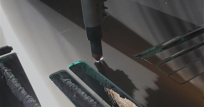 The process of cutting a metal part with a plasma cutter. Plasma cutting. Plasma cutter work at the factory. The plasma cutter will cut the part.