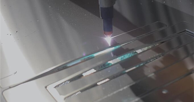 The process of cutting a metal part with a plasma cutter. Plasma cutting. Plasma cutter work at the factory. The plasma cutter will cut the part.