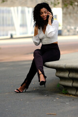 business woman resting on a bench and pacing while talking on the phone about work issues