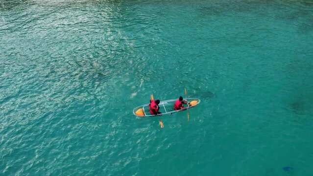 Two people having problems kayaking while on vacation at Perhentian Island, Terengganu, Malaysia. 4K slow-motion