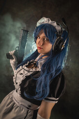 Fototapeta premium Girl with the rifle on the dark background.