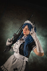 Fototapeta premium Girl with the rifle on the dark background.