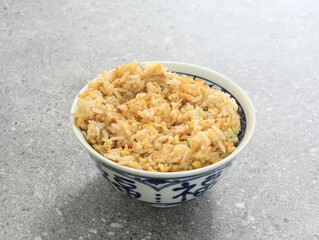 A bowl of egg fried rice on the table