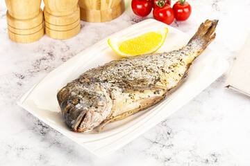 Baked Dorado fish served lemon
