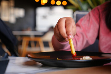 detail shot of French Fries sipping mayonnaise on table