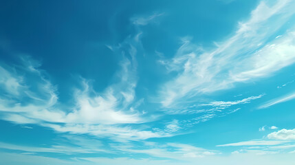 Clear blue sky with wispy clouds creating a serene and calm atmosphere.