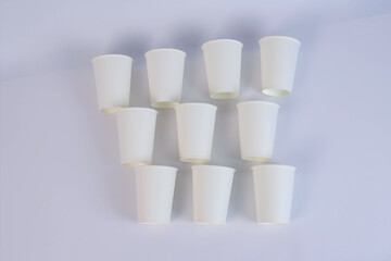  many white glasses lie on a cardboard table. High quality photo