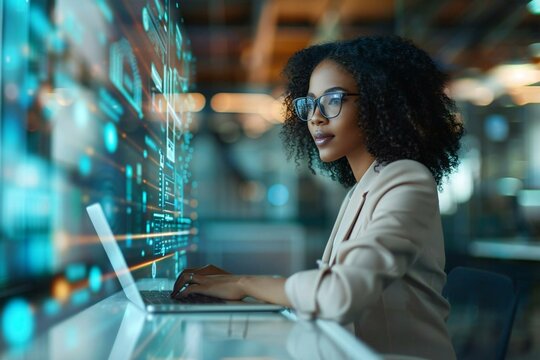 Beautiful African American businesswoman with futuristic holographic screens displaying AI financial data while banking online on a laptop in a high-tech office.