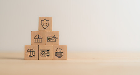 Cyber security network and data protection in financial business concept. Wooden cube blocks with the symbols of the managing  data and system to safeguard sensitive information from cyber threats.