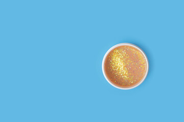 Glitter eye patches on blue background, collagen mask, spa care, glamorous facial
