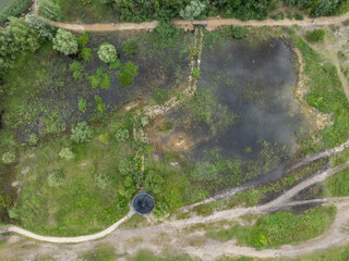 Aerial drone photo of Quarry  turquiose lake colour, open pit mining in Park Grodek, Jaworzno. Poland. Turquiose Water and Wooden Bridge. Polish Maldives Park Grodek in Jaworzno.
