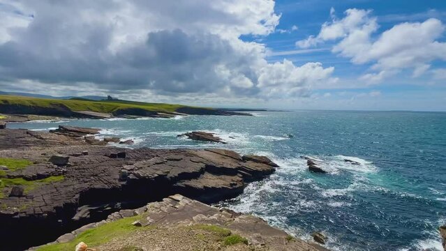 Waves gently washing over rocky shore at Mullaghmore, County Sligo