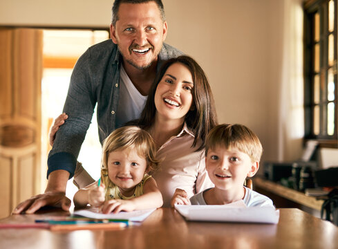 Family, portrait and homework with children, drawing and notepad with parents teaching for learning. Kids, home school or study with siblings, mother and father in kitchen for growth or development