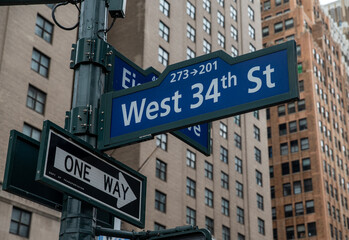 West 34th St sign along city streets, NYC United States tourist attractions