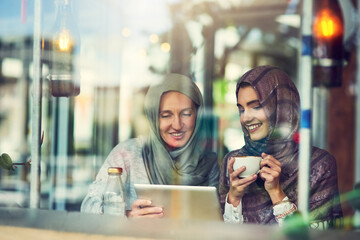 Tablet, friends and women with hijab in cafe for menu, decision or halal food option by window. Service, choice and muslim people with coffee for hospitality, online application or customer review