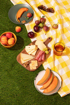 Outdoor summer picnic setup with fresh fruits and snacks