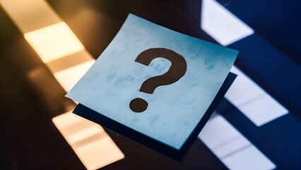 Blue sticky note with a question mark, placed on a reflective surface