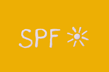 Fototapeta premium Sunscreen SPF cream on yellow background