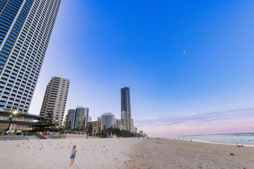 Little boy running along the sand on Gold Coast beach