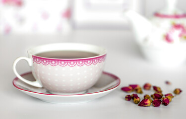 Tea rose flowers and cup of tea