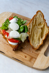 Caprese Croissant Sandwich with Mozzarella Cheese and Tomatoes.