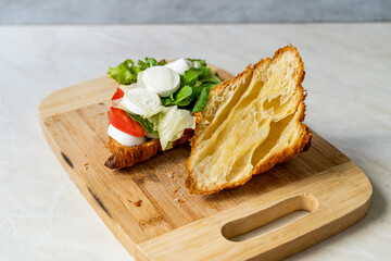 Caprese Croissant Sandwich with Mozzarella Cheese and Tomatoes.