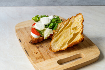 Caprese Croissant Sandwich with Mozzarella Cheese and Tomatoes.