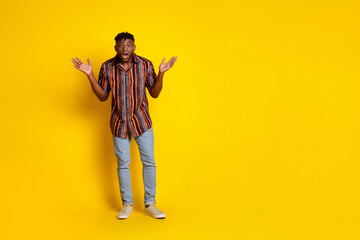 Full body portrait of nice young man empty space ad wear shirt isolated on yellow color background