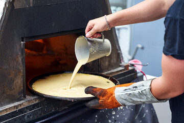 Socca being prepared in the oven in Nice, the French Riviera. Socca is a specialty of southeastern French cuisine. a pancake made from chickpea flour.