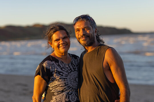 upper body shot of mature aboriginal couple together on the beach