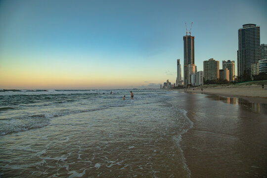 Children swimming at Main Beach on the Gold Coast at last light