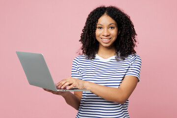 Little kid teen IT girl of African American ethnicity wears blue striped t-shirt casual clothes...
