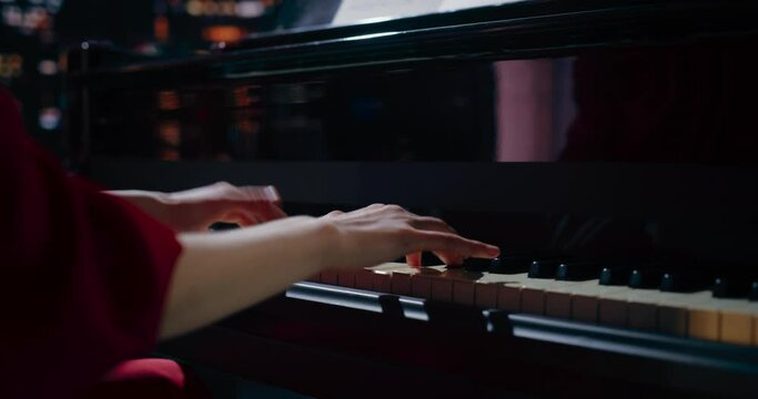 Close Up on Pianist Hands Practicing to Play Jazz on a Grand Piano. Female Musician is Focused on Creating Beautiful Instrumental Song as She Undergoing a Learning Process