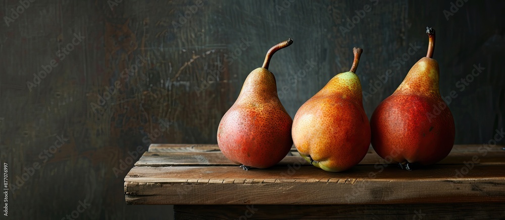 Aufkleber ripe pears displayed on a wooden table with a dark background, providing a copy space image.