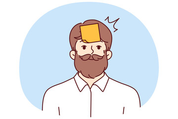 Hipster man with sticky notes on forehead looking at camera smiling. Hipster guy with mustache and beard tries to guess what is written on sticker playing with colleagues or friends