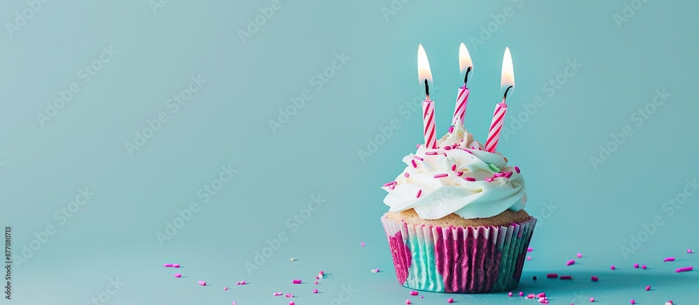 Aufkleber A birthday cupcake with pink candles against a blue backdrop, ideal for adding text or graphics with copy space image.