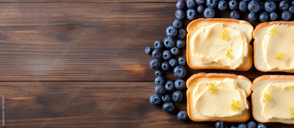 Aufkleber top view of delectable toasts with butter and blueberries on a rustic grey wooden table, with room f