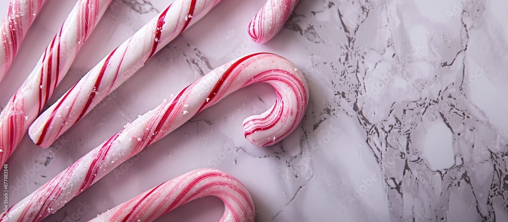 Poster Candy canes displayed with a marble backdrop, providing an elegant frame for the confectionery in a visually appealing copy space image.