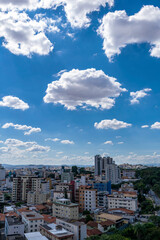 Beautiful blue sky with clouds. Residential buildings. Space for advertising. Vertical.
