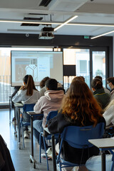 Students Engaged in Learning at University Classroom with Laptops and Blackboard