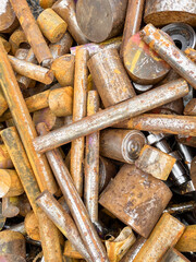 Rusty steel bars in a heap industrial waste ready to be recycled