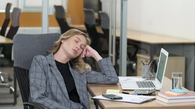 Professional woman sleeping in the office. Business woman having a nap at her office desk.