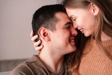 Obraz premium Happy Valentine's Day. Beautiful blonde woman hugging her boyfriend tenderly. Romantic evening at home