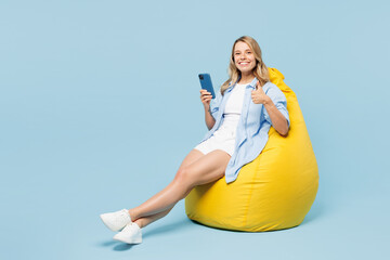 Full body young happy woman she wears white top shirt casual clothes sit in bag chair hold in hand...