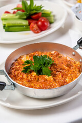 Turkish traditional menemen dish made with eggs, onions, peppers and tomatoes