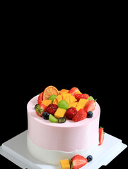 A close-up of a fruitcake on a black background