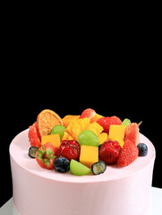 A close-up of a fruitcake on a black background