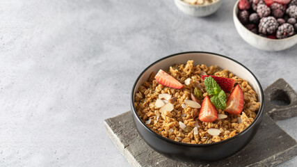 Homemade granola with fresh strawberries and mint. Healthy food. Copy space